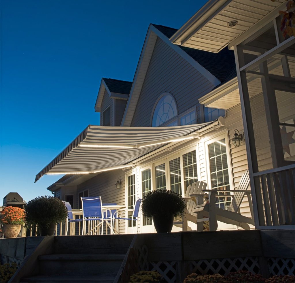 retractable awning in evening with lights